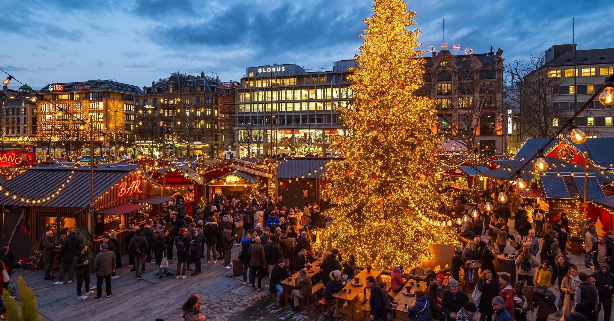 Zurich Christmas Market with a glowing tree, festive stalls, and crowds enjoying winter in the city center..jpg