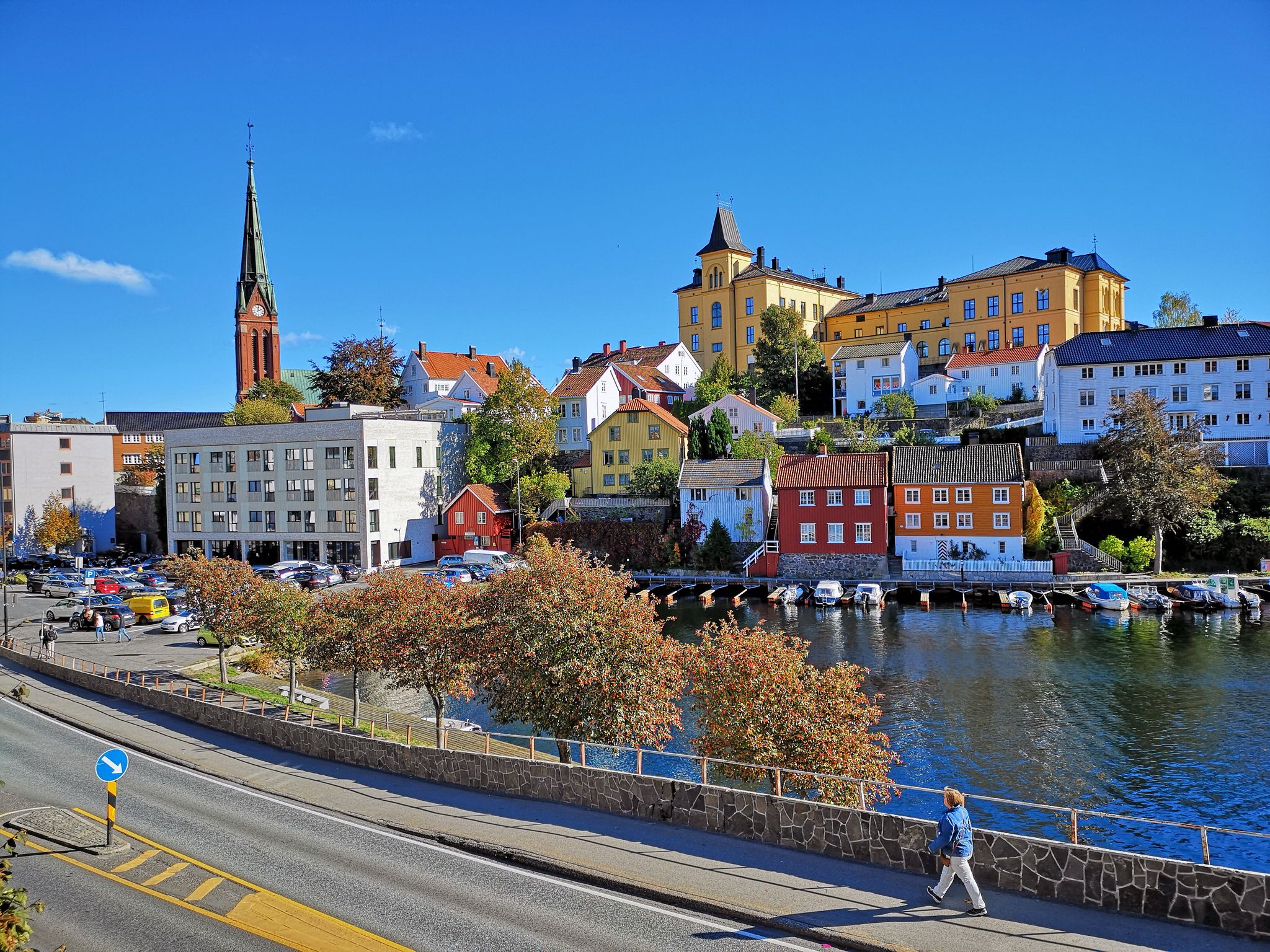 Sea view over the sea. Arendal city, Norway. city view, Arendal, Norway in the spring time on the nice sunny day. boats sit moored at the city habour With colorful house along the sea.