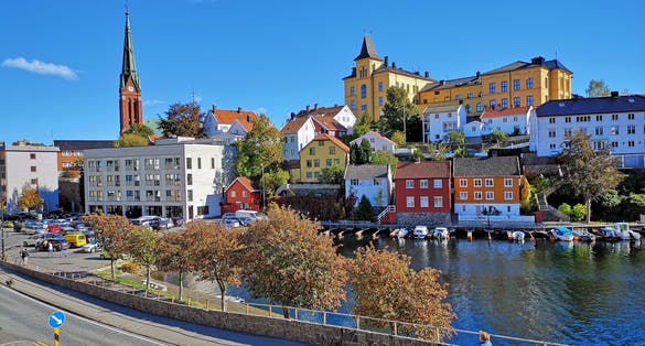 Sea view over the sea. Arendal city, Norway. city view, Arendal, Norway in the spring time on the nice sunny day. boats sit moored at the city habour With colorful house along the sea.