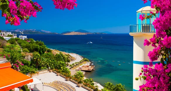 Photo of Bougainvillea frames a view across a bay in Ortakent near Bodrum.
