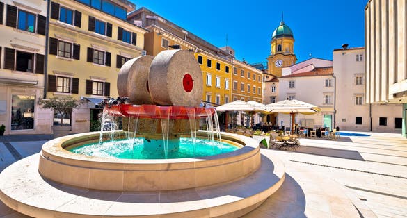 Photo of Rijeka square and fountain view with clock tower gate, Kvarner, Croatia.