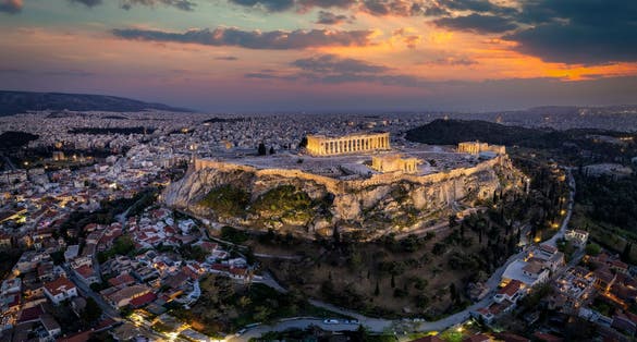 Photo of panoramic view of the illuminated Acropolis of Athens, Greece.