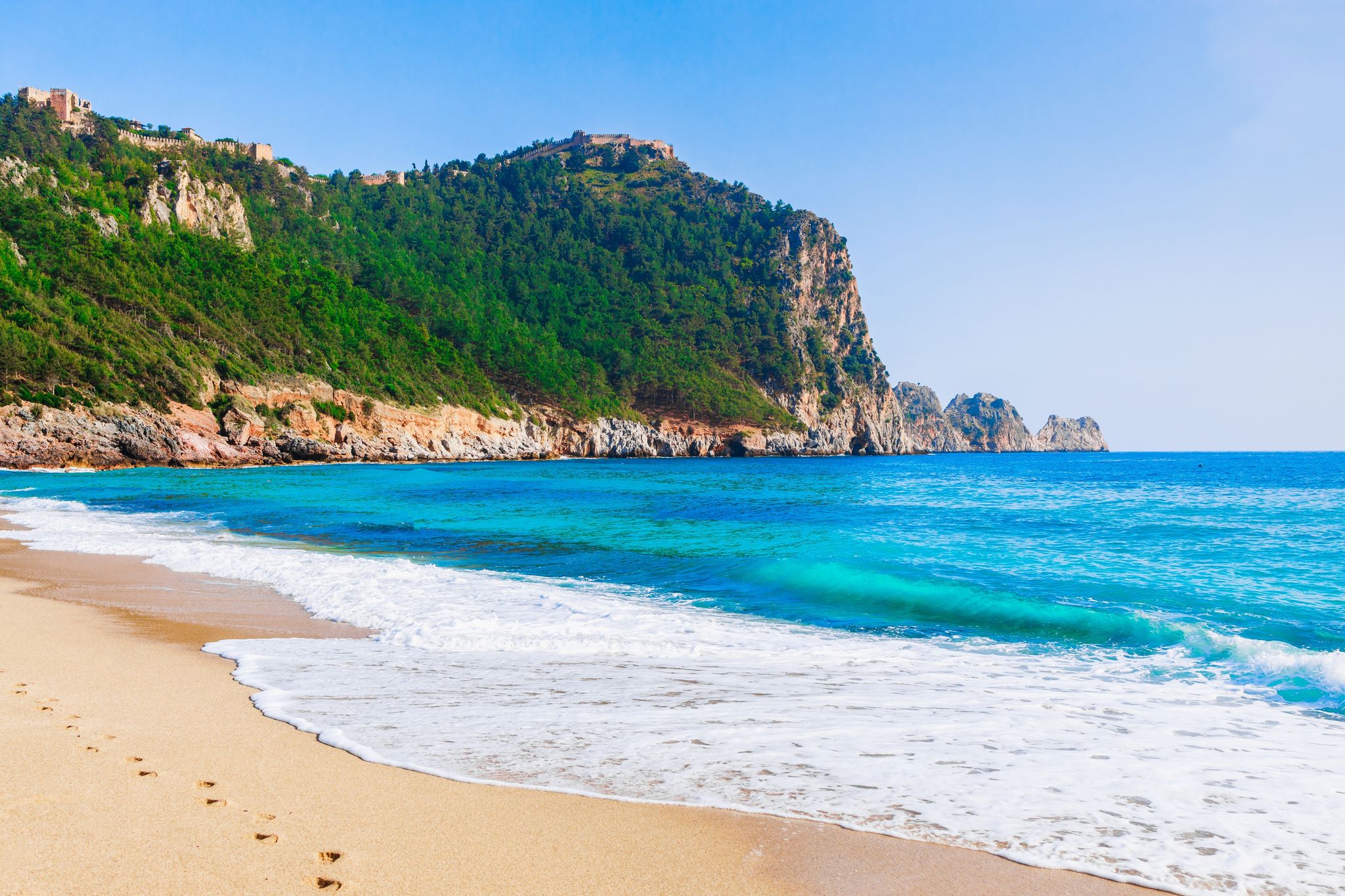 photo of Cleopatra beach with sea, sand and rocks in Alanya, Antalya, Turkey.