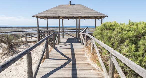 photo  of view of Punta Candor beach, Rota, Cadiz, Spain. Fishing weir, fish weir, fishgarth or kiddle