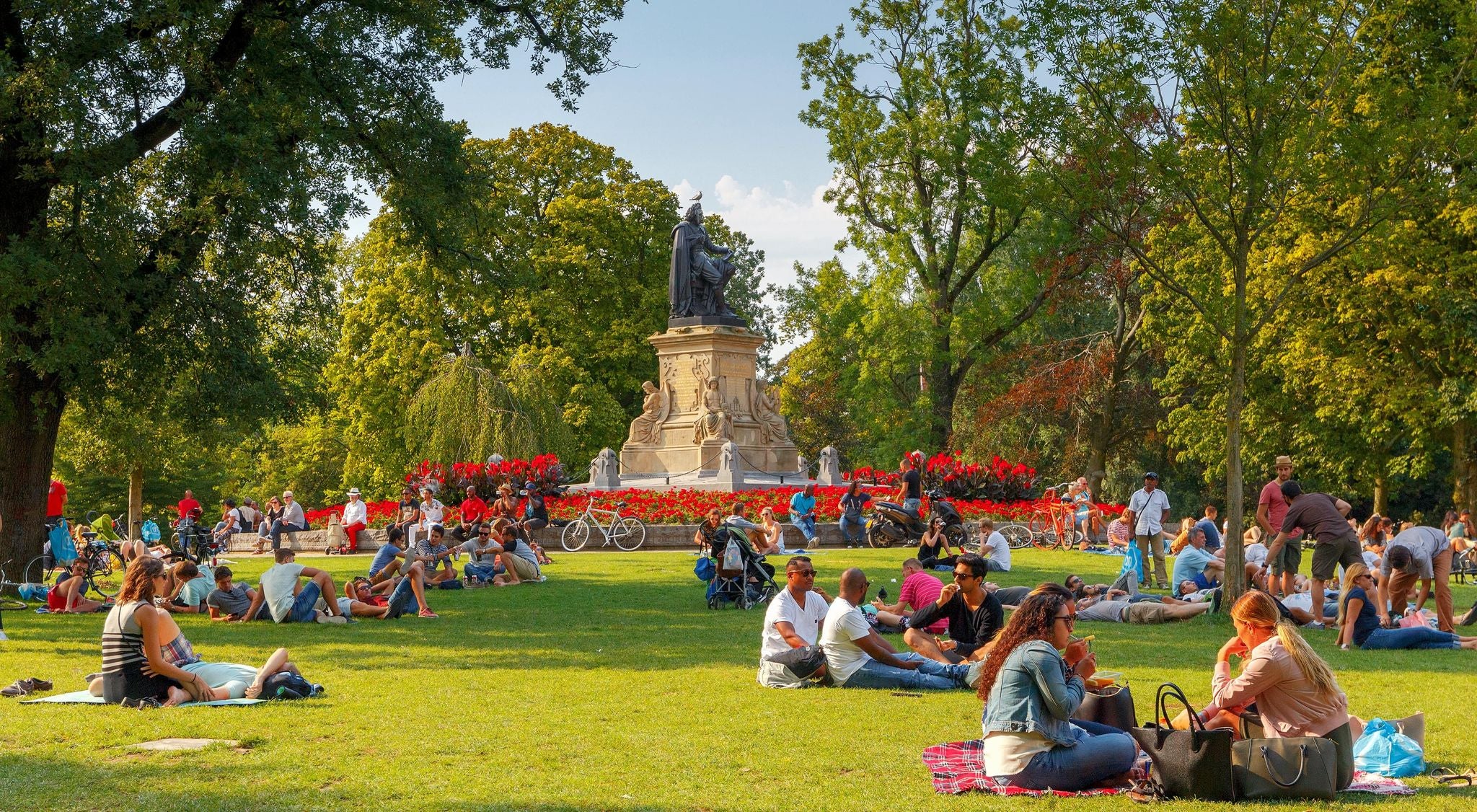 People enjoying a sunny afternoon picnic in Vondelpark, Amsterdam in August..jpg