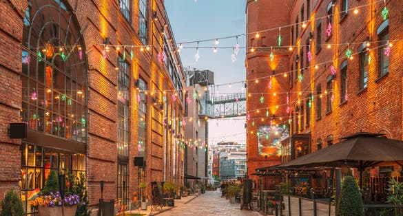 photo of view of Oslo, Norway. Evening View Of Old Houses In Aker Brygge District. Summer Evening. Famous And Popular Place.