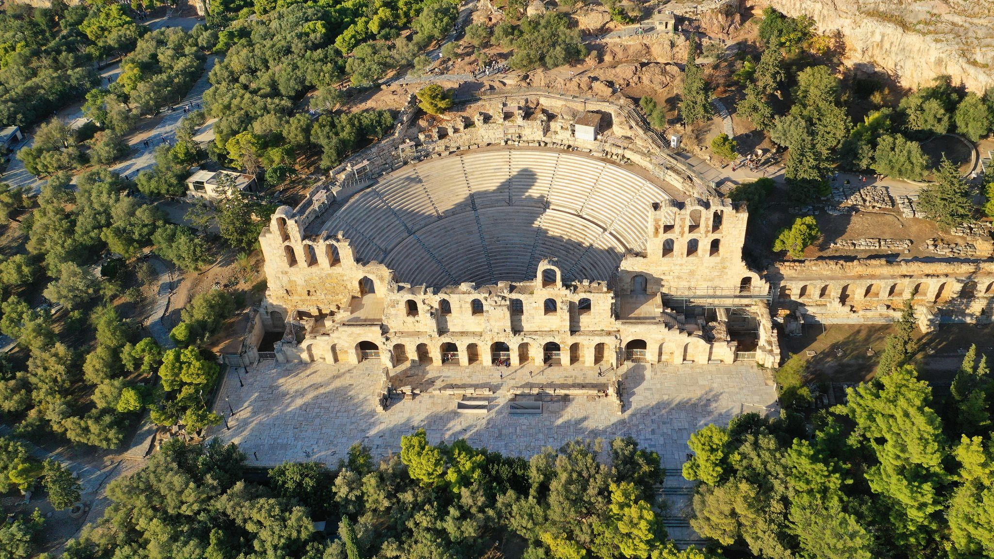 Photo of aerial drone view from iconic ancient theatre of Herodes Atticus near Acropolis hill, Athens historic centre, Attica, Greece.