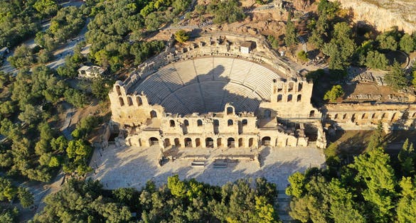 Photo of aerial drone view from iconic ancient theatre of Herodes Atticus near Acropolis hill, Athens historic centre, Attica, Greece.