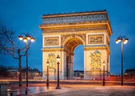 Photo of Arc de Triomphe de l'Étoile (Triumphal Arch of the Star) at night, Paris, France.
