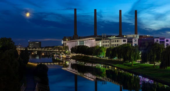 photo of view  of Car plant by canal in Wolfsburg in moon light.