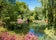 Photo of beautiful flower garden and a small pond in the spring season in Richmond Park, London, England.