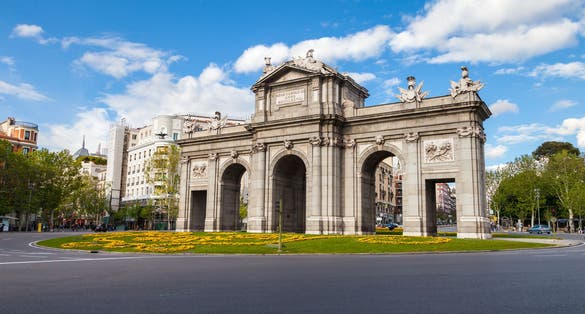 photo of the Puerta de Alcala is a monument in the Independence Square at morning in Madrid, Spain.