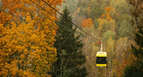 Cablecar Sigulda and Thick colourful forest in autumn season in Gauja National Park, Sigulda, Latvia.