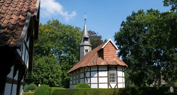 Church and house in Museumdorf Cloppenburg (Germany)
