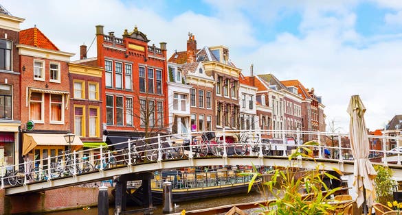 Traditional dutch houses near canal, bridge and bicycles in downtown of Leiden, Holland