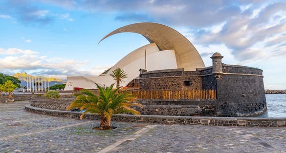 photo of beautiful view of Auditorium Adan Martin behind castle of San Juan Bautista at Santa Cruz de Tenerife, Canary Islands, Spain.