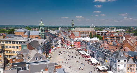 Aerial skyline summer view of vibrant central square (Grand-Place de Mons) and town hall of Mons (Bergen). Wallonia, capital of Hainaut, Belgium.