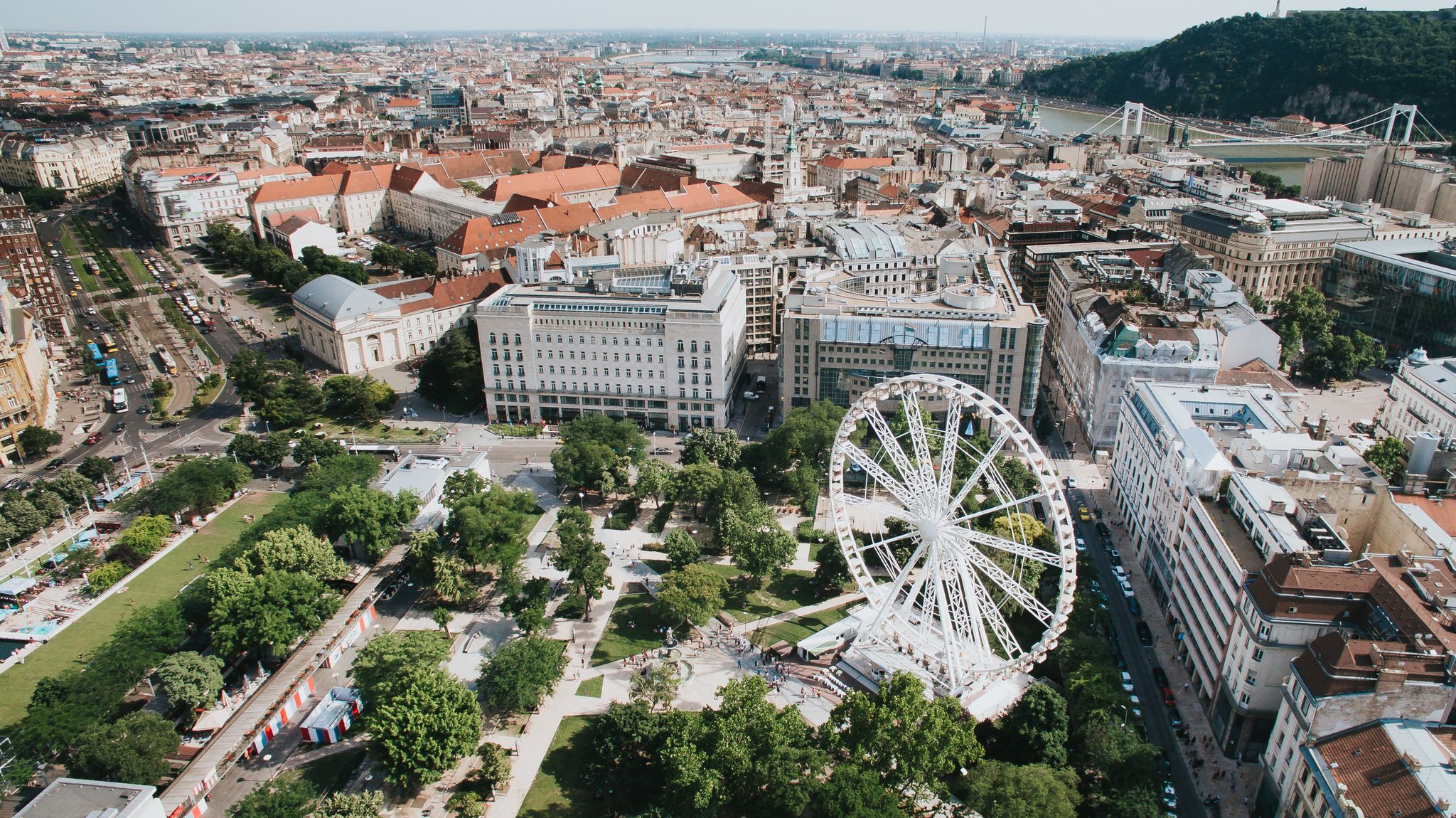 Photo of aerial view of Budapest Eye (ferris wheel) at Erzsebet Square. Luminous Ferris wheel in night city.