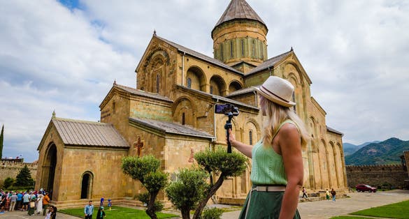 Photo of a girl tourist at Svetitskhoveli Cathedral near Tbilisi, Mtskheta, Georgia.