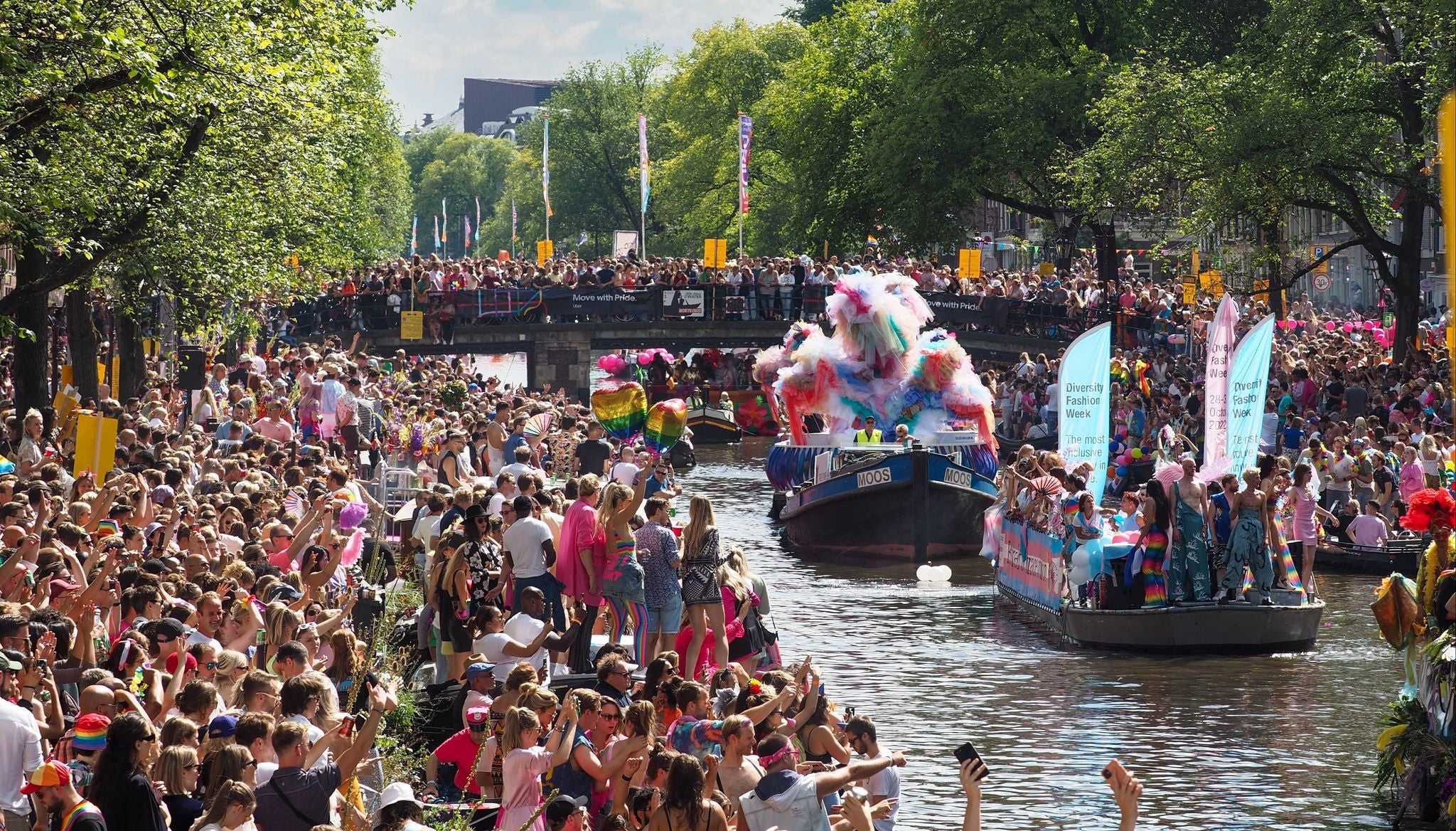 Colorful boats and cheering crowds at the Amsterdam Pride Canal Parade in August..jpg