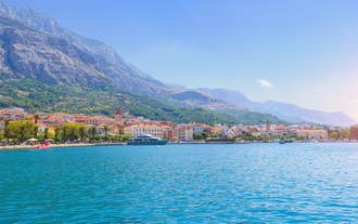 Photo of aerial view on Adriatic Sea and Baska Voda place in Makarska Riviera, Dalmatia region, popular tourist summer resort in Croatia.