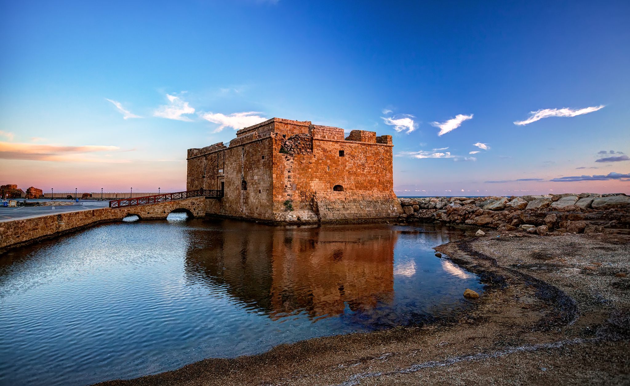 Photo of the castle of Paphos early in the morning with reflection on the water.