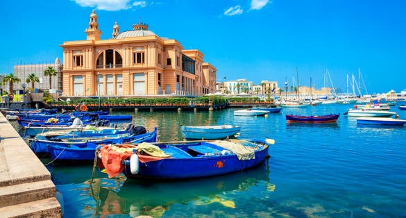 Margherita Theater and fishing boats in old harbor of Bari, Puglia, Italy. Bari is the capital city of the Metropolitan City of Bari on the Adriatic Sea, Italy. Architecture and landmark of Italy.