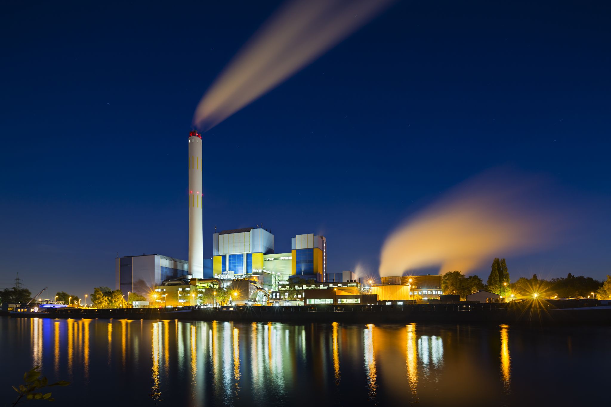 Photo of colorful night view of a modern waste incineration plant in Oberhausen, Germany.