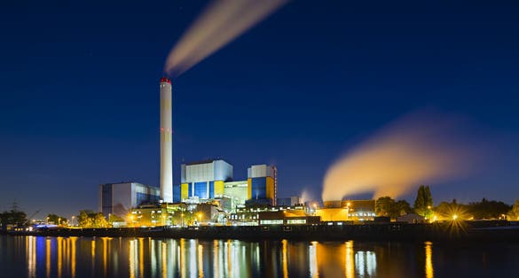 Photo of colorful night view of a modern waste incineration plant in Oberhausen, Germany.