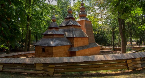 Photo of Wooden temple Church of St. Nicholas originally from Slovak village Habura in Hradec Kralove gardens, old historic building during summer.