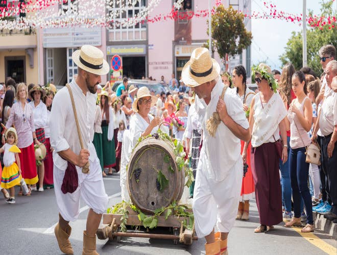 Parade participants hauling a grape barrel during the Madeira Wine Harvest Festival in Portugal in August..jpg