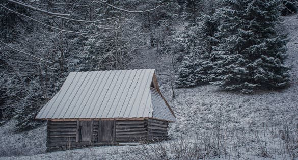 Old wooden chalet in Dolina Strążyska Valley, Western Tatra Mountains, Poland. Historical architecture used by Podhale shepherds. Selective focus on the exterior of the building, blurred background.