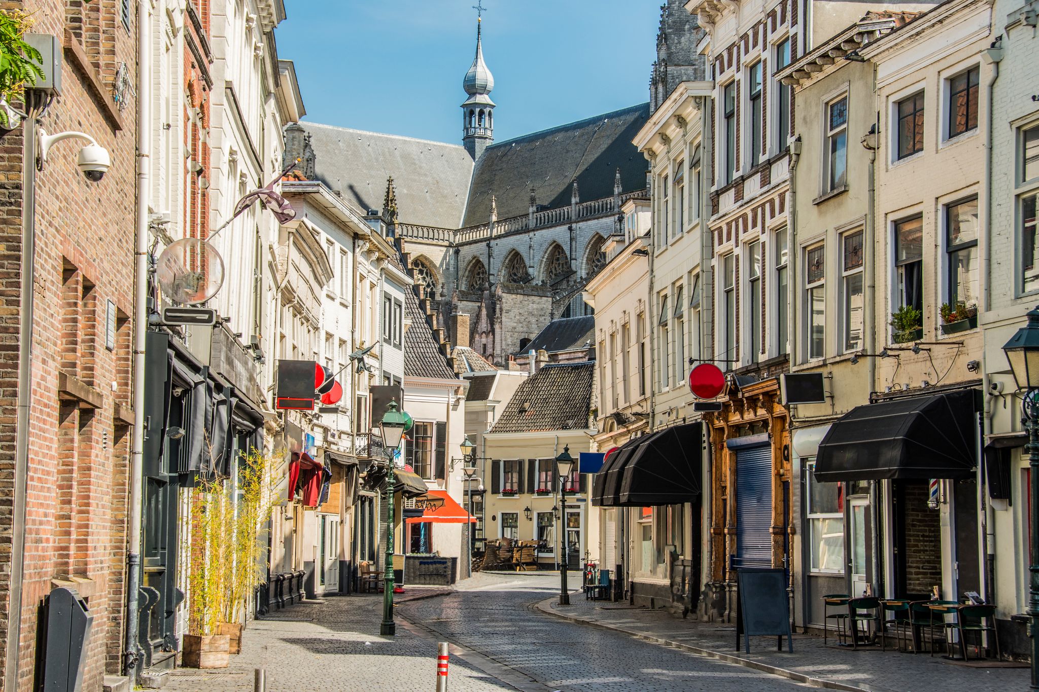 photo of view of commercial street in the center and behind the great church of the city of Breda, Netherlands.