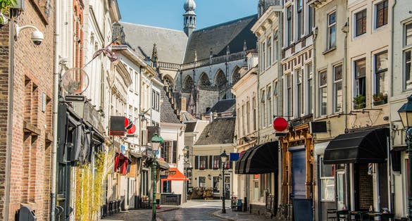 photo of view of commercial street in the center and behind the great church of the city of Breda, Netherlands.