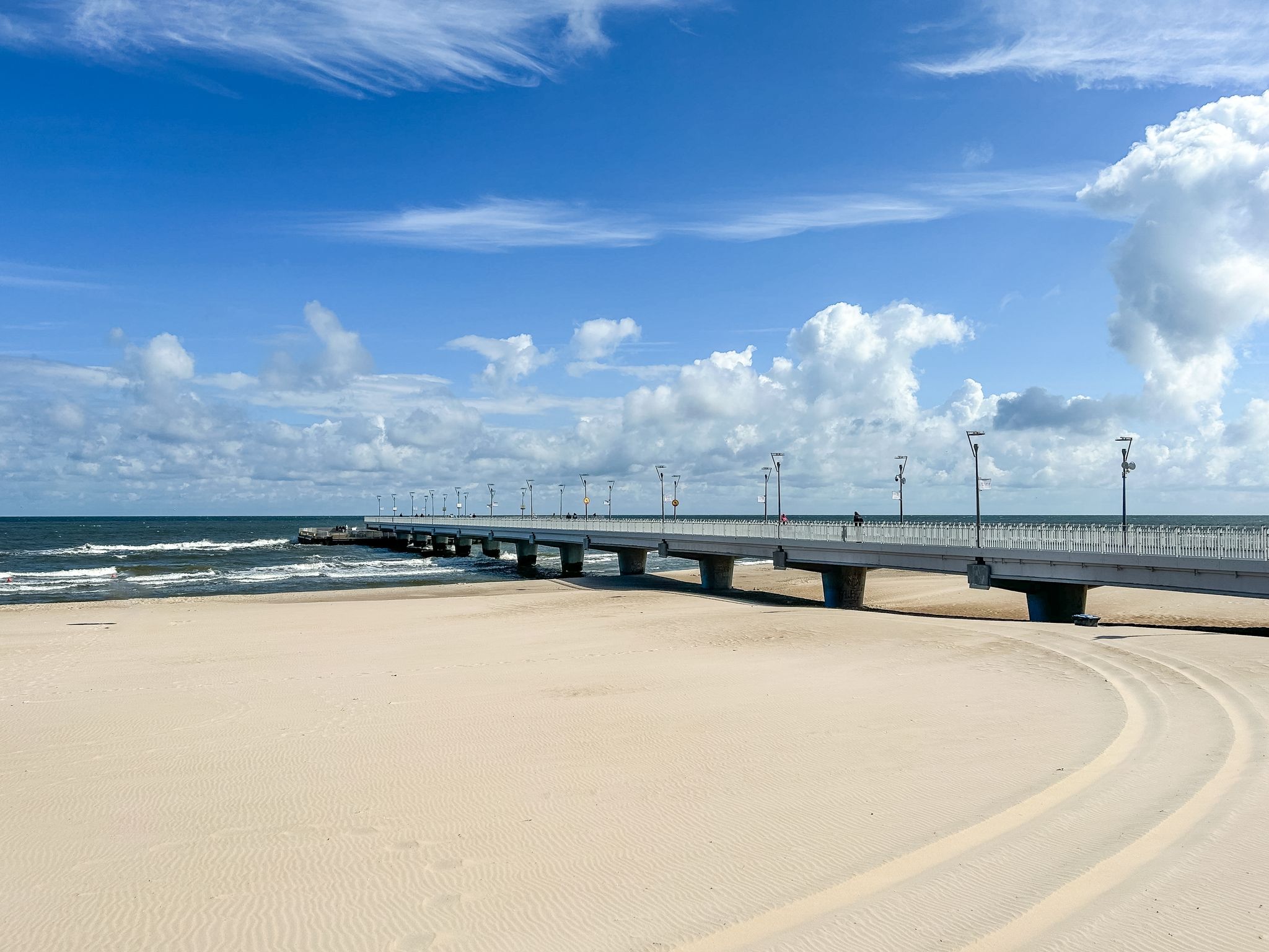 Photo of concrete pier on the Baltic Sea on a sunny day in Miedzyzdroje, Poland.
