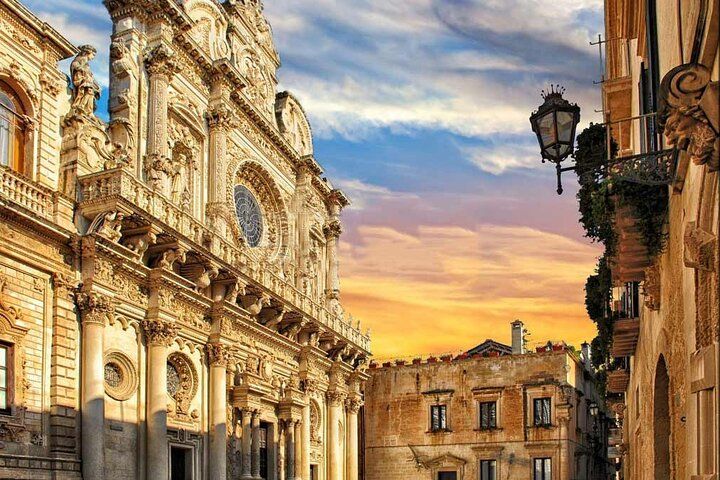 Historic Baroque church in Lecce, Italy, lit by golden sunset light with dramatic skies above..jpg
