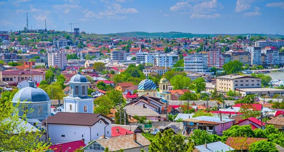 Photo of aerial view over the city of Tulcea in Romania, old and new buildings cityscape.