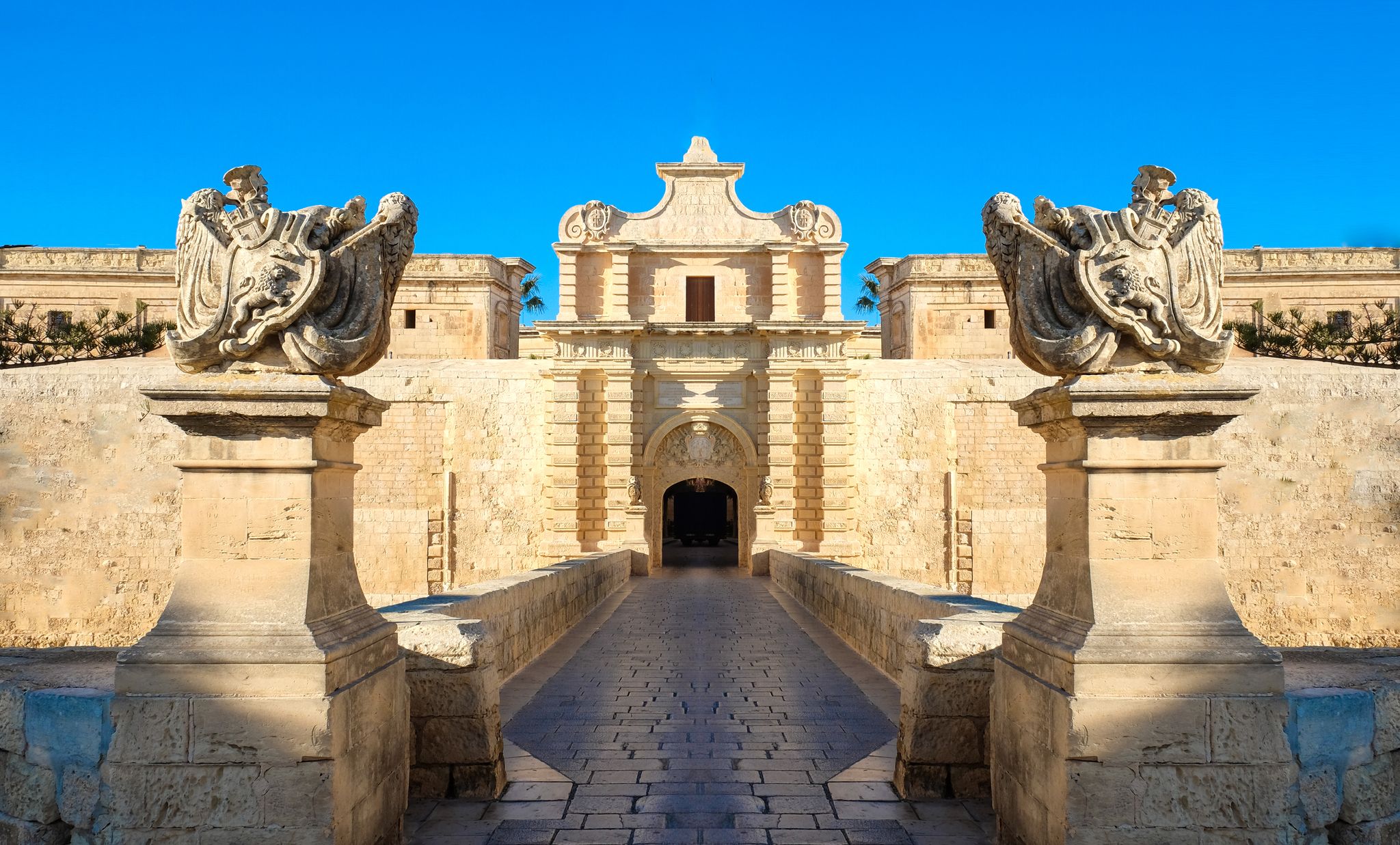 Photo of entrance bridge and gate to Mdina, a fortified medieval city in the Northern Region of Malta.