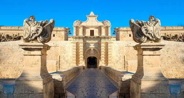 Photo of entrance bridge and gate to Mdina, a fortified medieval city in the Northern Region of Malta.