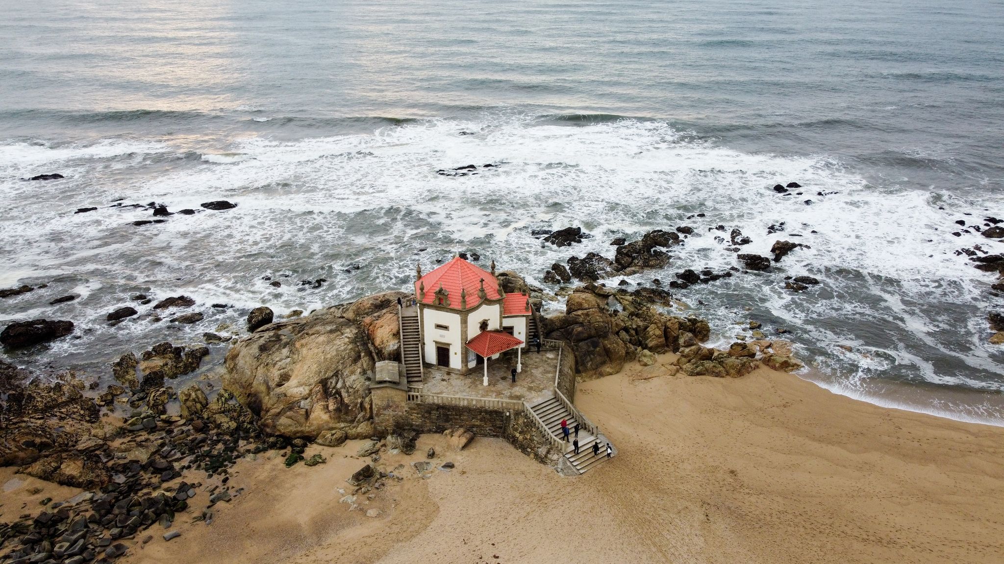 Aerial drone view over the Chapel of Senhor da Pedra at Miramar beach, Gulpilhares, Vila Nova de Gaia - Portugal