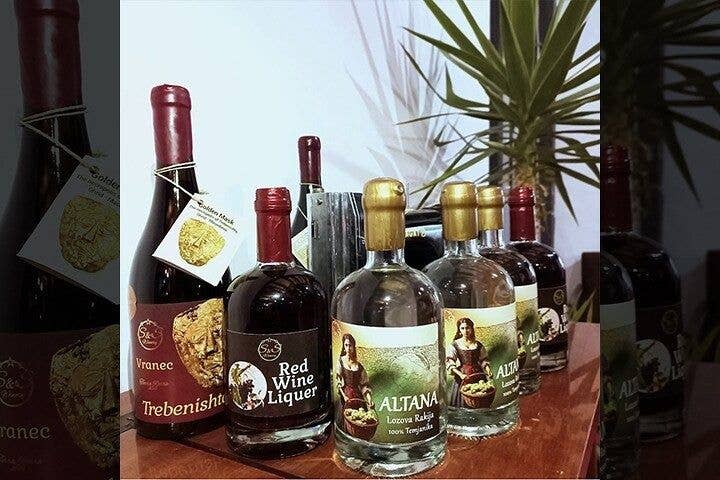 Bottles of Macedonian wine, red wine liqueur, and rakija displayed on a wooden table in North Macedonia..jpg