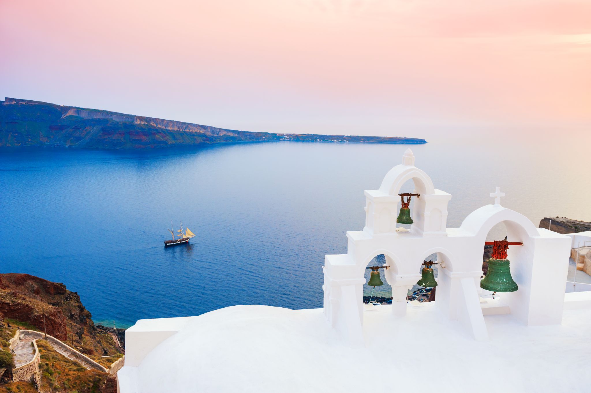 Photo of white architecture on Santorini island with beautiful view on the beach, Greece.