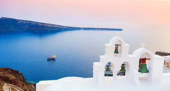 Photo of white architecture on Santorini island with beautiful view on the beach, Greece.