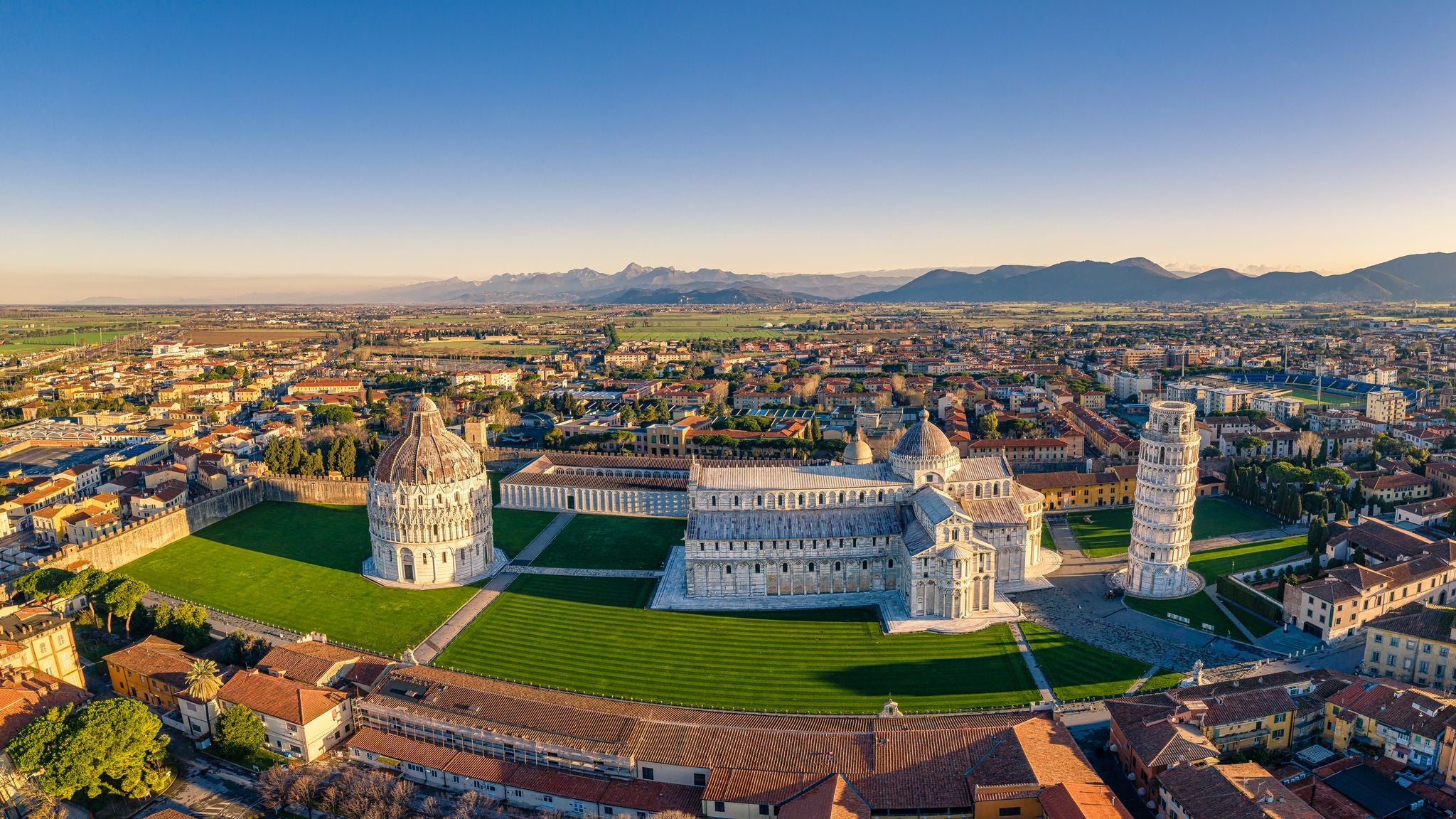 photo of aerial image of the square of miracles with pisa’s leaning tower, Cathedral of santa maria assunta and baptistery in Pisa, Tuscany, Italy.