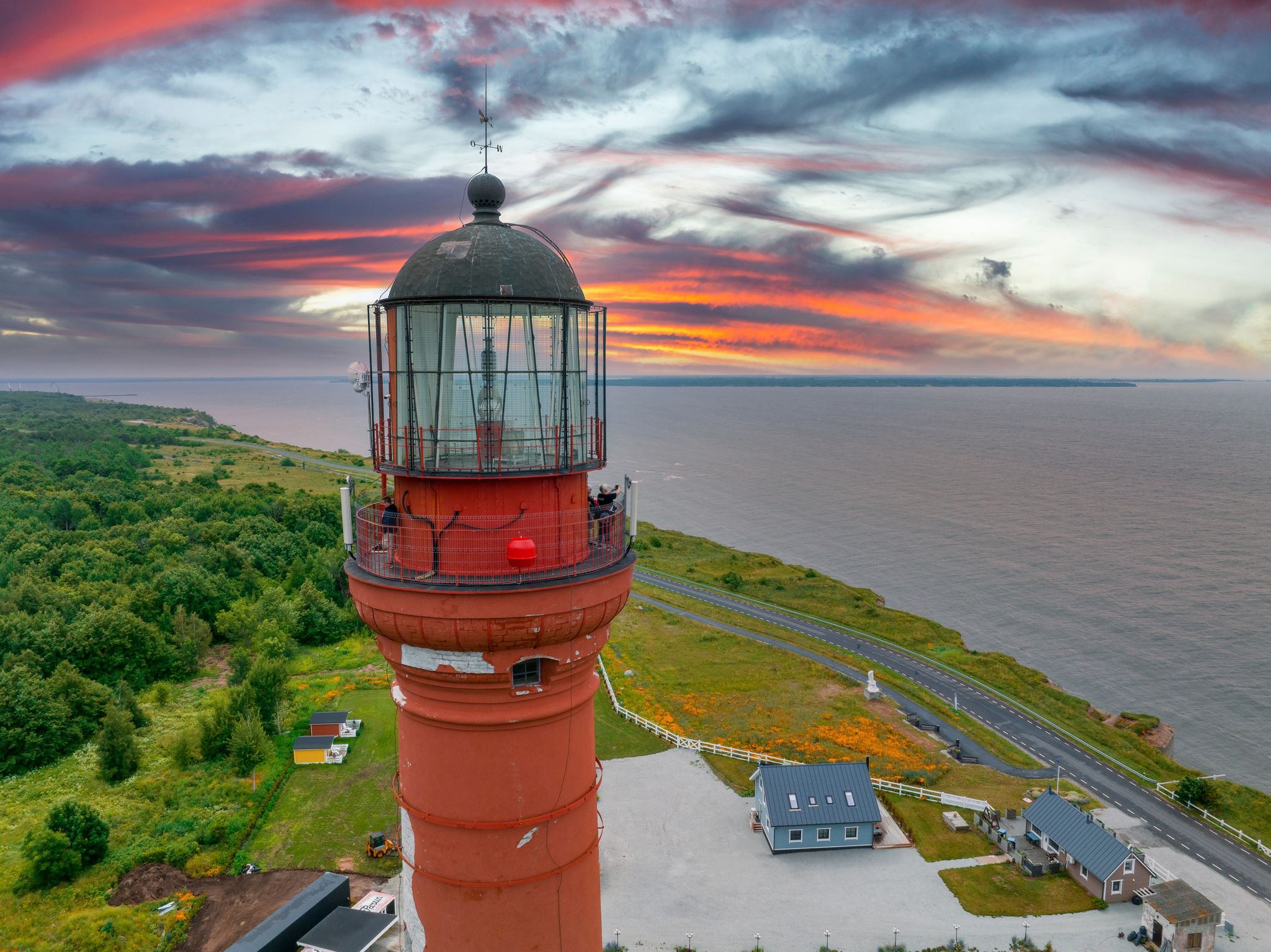Photo of beautiful limestone cliff on Pakri peninsula, Estonia with the historic lighthouse. One of the oldest lighthouses in Europe at sunset.