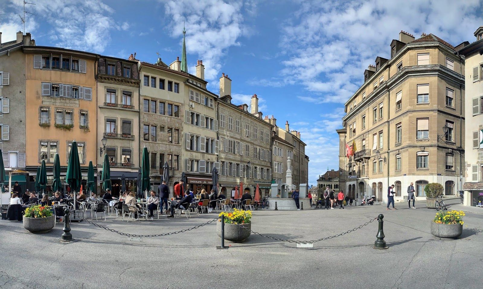 photo of people sitting in a cafe in Place du Bourg-de-Four City Square in Geneva, Switzerland.
