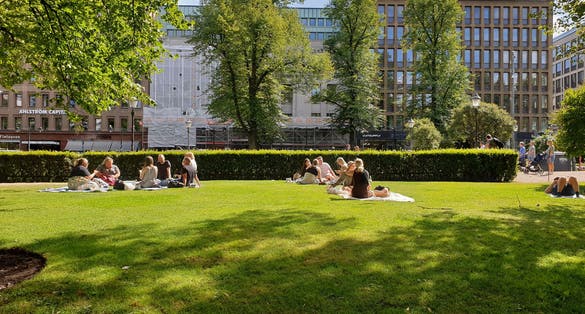 Photo of People are enjoying a sunny summer day having a picnic in the Esplanadi park.