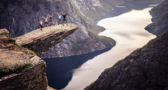 People on rocks harsh Norway, Trolltunga
