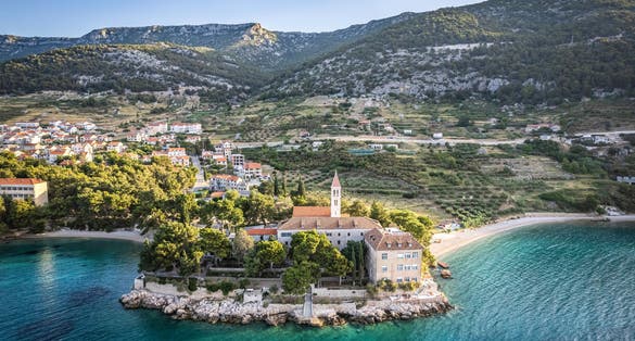 Photo of beautiful aerial view of Dubrovnik Dominikanski Samostan (Dominican Monastery, 1225) and the orange-tiled roofs of Old Town. Dubrovnik, Croatia.