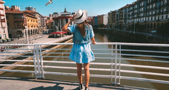 Photo of tourist woman walking in Bilbao city, summer holiday vacation in Spain.